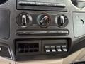 Dashboard controls of a 2008 Ford F-450 SD featuring knobs for air conditioning and auxiliary switches