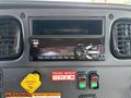Dashboard of a 2019 Freightliner M2 106 featuring a radio control panel with buttons and a digital display for FM tuning and time