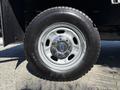 A close-up of a 2012 Ford F-350 SD wheel featuring a Bridgestone tire and a silver rim with the Ford logo in the center