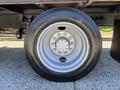 A close-up of a tire mounted on a wheel of a 2011 International 4300 truck showing five lug nuts and a silver rim with a circular design