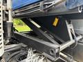 A close-up view of the hydraulic system and supports of a 2017 Autocar Xpert with black metal frames and various hydraulic lines attached