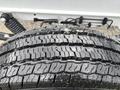 A close-up of the tread pattern on a wet tire from a 2023 RAM Promaster 3500 showcasing grooves and surface details
