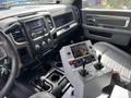 Interior view of a 2016 RAM 5500 featuring a gray control panel with multiple switches and joysticks positioned on the center console alongside keys and other controls