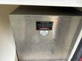 A metal utility box with a warning label attached indicating attention to battery and inverter fuse connections