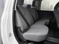 Rear seating area of a 2013 RAM 3500 with gray upholstery and seat belts visible