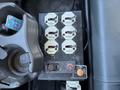 A control panel featuring eight Haldex connections with labels and a switch for the tailgate control on a vehicle interior