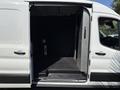 2022 Ford Transit van with open side door revealing a spacious interior designed for cargo transport