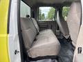 Interior view of a 2010 Ford F-550 Super Duty showing the back seat with fabric upholstery and seatbelts