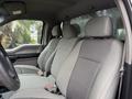 Interior view of a 2018 Ford F-150 showing the front seats with gray fabric upholstery and a black steering wheel