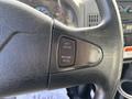 Close-up of the cruise control buttons on the steering wheel of a 2012 International DuraStar 4300 indicating set resume and accelerate functions