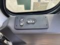 Close-up of the control panel inside a 2012 International DuraStar 4300 featuring buttons for door operation and window control