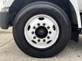Close-up of a 2018 Ford F-750 wheel featuring a white rim with multiple lug nuts and a large black tire with visible tread patterns