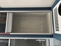 A 2020 Mercedes-Benz Sprinter 2500 interior cabinet with a spacious empty compartment labeled for sanitary supplies