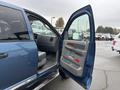 A 2006 Dodge Ram 2500 with the driver's door open showing the interior and seat details