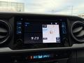 A 2016 Toyota Tacoma's dashboard displaying a navigation screen with a map and time readout
