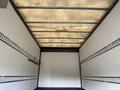 Interior view of a 2014 Hino 195 truck's cargo area with metal rails along the sides and a textured ceiling