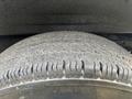 Close-up of a worn tire from a 2021 Chevrolet Express showing visible tread wear and rough texture on the rubber surface