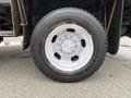 A close-up of a silver wheel on a 2011 Dodge Ram 5500 featuring a six-bolt pattern and a rugged tire tread