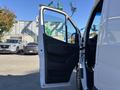 A white 2021 Mercedes-Benz Sprinter 2500 van with an open driver's side door showcasing the interior panel and seating area