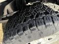 Close-up of a rugged tire from a 2011 Ford F-250 SD showcasing deep treads and textured rubber surface designed for traction on various terrains