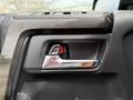 A close-up of the door handle of a 2021 Toyota 4Runner featuring a chrome trim and a red indicator light