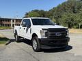 A white 2017 Ford F-350 SD pickup truck parked with a front view showcasing its large grille and chrome accents