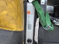 A close-up of a control unit labeled HWH with a model number AP3917 and a serial number attached to a green strap