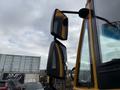 A close-up of the side mirrors on a 2022 Freightliner B2 school bus with a yellow exterior and a modern design displaying clear visibility features