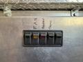 A set of five toggle switches labeled for fan heater and dome functions mounted on a metallic surface
