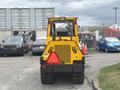 A yellow 2004 Bombardier SW48 with a textured rear panel and large rear lights designed for industrial use