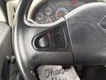Close-up of the steering wheel and controls of a 2013 International Workstar 7500 with assorted gauges partially visible in the background
