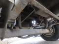 A 2015 Vermeer Corporation BC1200XL chipper showing the undercarriage with visible components including the exhaust system and suspension parts