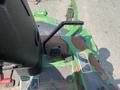 View of the controls and seat of a 2012 John Deere 1445 SERIES II 4WD tractor showing levers and foot pedals