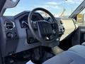Interior view of a 2010 Ford F-450 featuring a steering wheel dashboard controls and seating showing a modern truck design