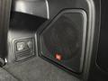 A JBL speaker mounted in a vehicle interior featuring a textured grille and a control panel for various settings