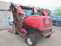 A red 2013 Toro Grounds Master 5910 with multiple mowing decks attached and elevated for maintenance showing wheels and engine compartment