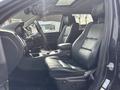 A 2015 Dodge Durango interior featuring black leather seats and a modern dashboard with controls and a sunroof above