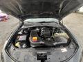 A 2015 Dodge Charger with the hood open revealing the engine compartment featuring an engine block battery and various components