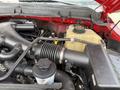 Close-up of a 2013 Ford F-550 engine showing the air intake system and coolant reservoir