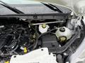 2023 Ford Transit engine compartment displaying various components including the engine block coolant reservoir and battery