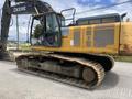 A yellow and gray 2018 John Deere 350 excavator with a large cab and caterpillar tracks positioned on a flat surface