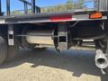 A 2011 International 4300 truck displaying its rear axle and exhaust system with exposed undercarriage components