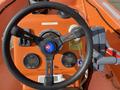 Close-up of the steering wheel and control panel of a 2007 Fassmer 20 Foot Fast Rescue Boat featuring gauges and navigation controls