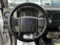 Interior view of a 2009 Ford F-550 showing the steering wheel dashboard instruments and console controls