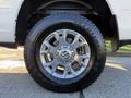 A close-up of a 2023 RAM 3500 wheel featuring a shiny silver rim and a thick black tire with the label Transforce on the sidewall