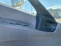 Interior door panel of a 2014 Hino 195 featuring window controls and a door handle