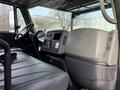 Interior cabin of a 2011 International 4300 featuring a driver's seat dashboard and control panel with gauges and controls