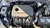 Engine compartment of a 2018 Hyundai Sonata featuring a GDI engine with various components including an intake system and battery