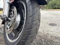 Close-up of a 2009 Harley-Davidson Road King motorcycle tire showcasing its tread pattern and chrome wheel