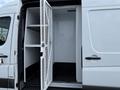 A 2012 Mercedes-Benz Sprinter with a cargo area featuring an open door and shelving inside